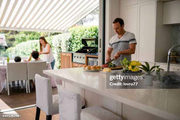 family preparing lunch - outdoor kitchen stock pictures, royalty-free photos & images