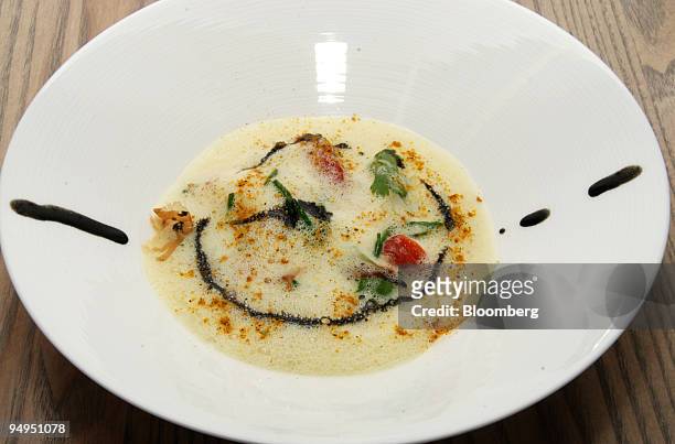 Baby cuttlefish coconut-curry soup with herb puree and squid ink is shown at Aldea restaurant in New York, U.S., on Saturday, June 13, 2009. Aldea is...