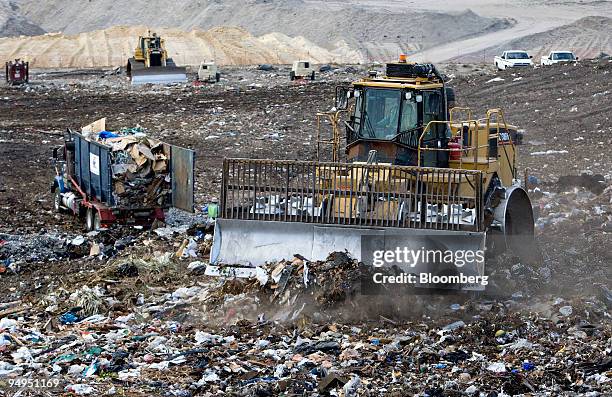 Caterpillar 836H landfill compactor drives over the active face of the Waste Management Central Landfill in Pompano Beach, Florida, U.S., on Friday,...