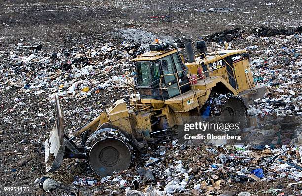 Caterpillar 836H landfill compactor drives over the active face of the Waste Management Central Landfill in Pompano Beach, Florida, U.S., on Friday,...