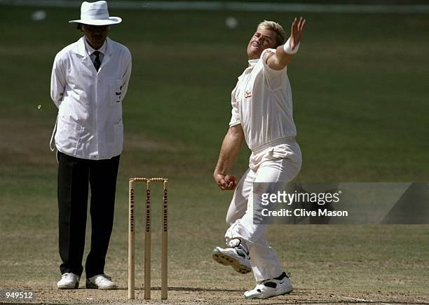 Shane Warne of Australia bowls during the First Test match against the West Indies at the Kensington Oval in Bridgetown, Barbados. \ Mandatory...