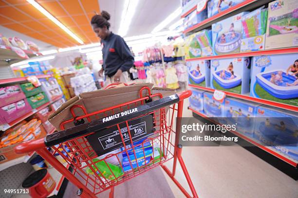 Store Manager, Sharon Dixon arranges a shelf at a Family Dollar store in Norcross, Georgia, U.S., on Tuesday, April 7, 2009. Family Dollar is due to...