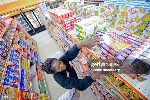 Store Manager Sharon Dixon restocks shelves at a Family Dollar store in Norcross, Georgia, U.S., on Tuesday, April 7, 2009. Family Dollar is due to...
