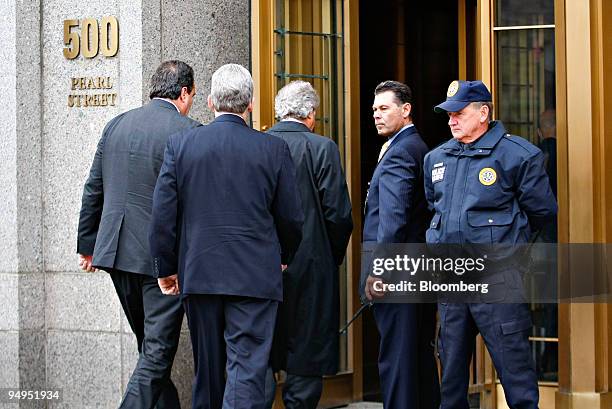 Bernard Madoff, founder of Bernard L. Madoff Investment Securities LLC, is escorted into Federal court in New York, U.S., on Tuesday, March 10, 2009....