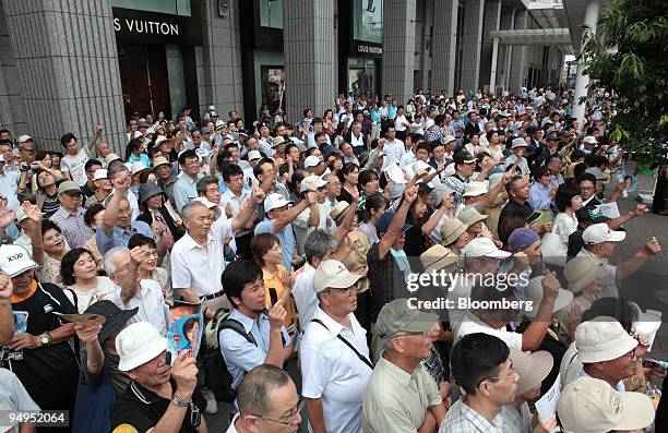 People listen to a speech by Yukio Hatoyama, president of the Democratic Party of Japan , unseen, during a campaign rally for the Aug. 30 lower-house...