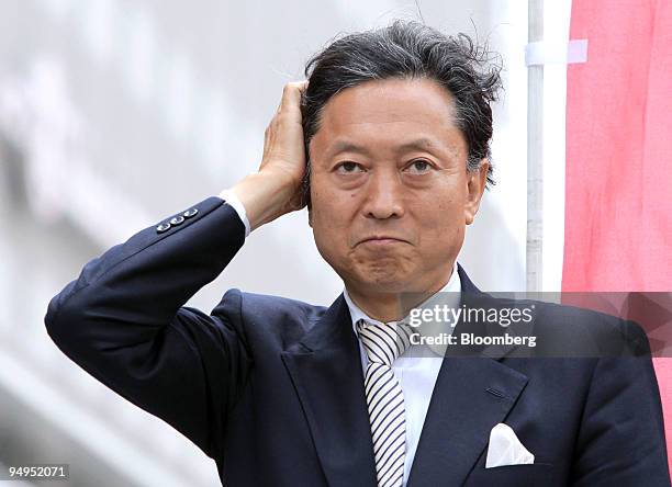 Yukio Hatoyama, president of the Democratic Party of Japan , adjusts his hair during a campaign rally for the Aug. 30 lower-house election in...