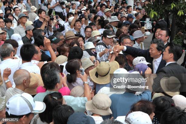 Yukio Hatoyama, president of the Democratic Party of Japan , shakes hands with people gathering at a campaign rally for the Aug. 30 lower-house...