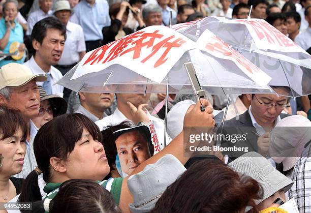 People listen to a speech by Yukio Hatoyama, president of the Democratic Party of Japan , unseen, during a campaign rally for the Aug. 30 lower-house...