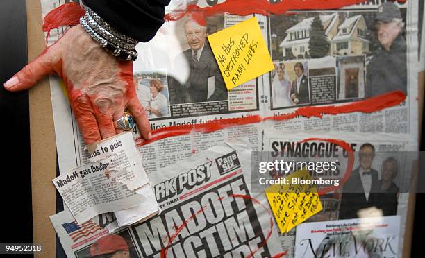 Artist Karen Dweck displays a collage of newspaper clippings on Bernard Madoff, founder of Bernard L. Madoff Investment Securities LLC, while Madoff...