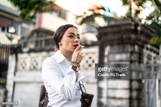 businesswoman walking and smoking - beautiful women smoking cigarettes stock pictures, royalty-free photos & images