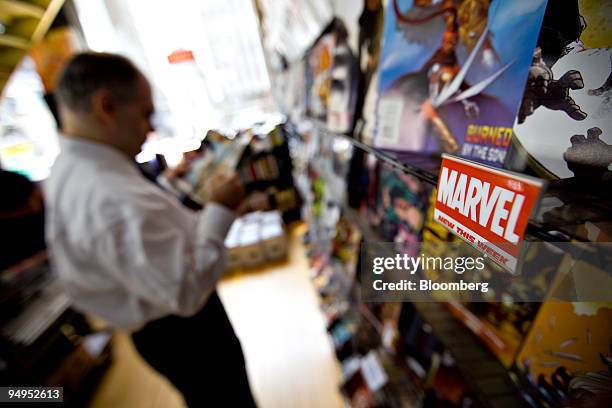 Customer looks over a Marvel comic book at Midtown Comics in New York, U.S., on Monday, Aug. 31, 2009. Walt Disney Co. Said it agreed to buy Marvel...