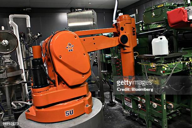 An Asea Brown Boveri AG robotic arm demonstrates its chemical pouring capabilities inside an Eastman Kodak Corp. Film processing facility in...