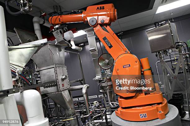 An Asea Brown Boveri AG robotic arm demonstrates its chemical pouring capabilities inside an Eastman Kodak Corp. Film processing facility in...