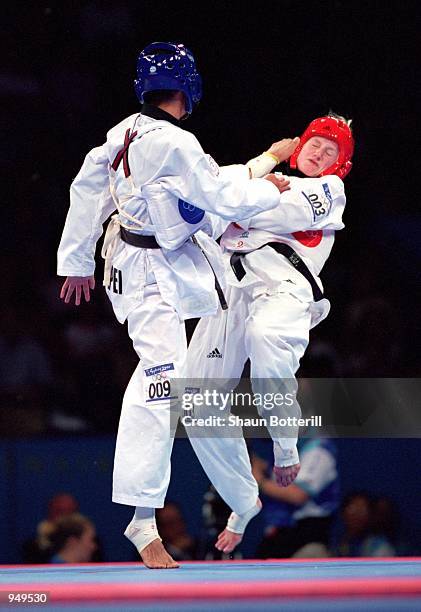 Shu-Ju Chi of Chinese Taipei kicks Hanne Hoegh Poulsen of Denmark in the Womens 49kg Taekwondo contest at the State Sports Centre on Day 12 of the...