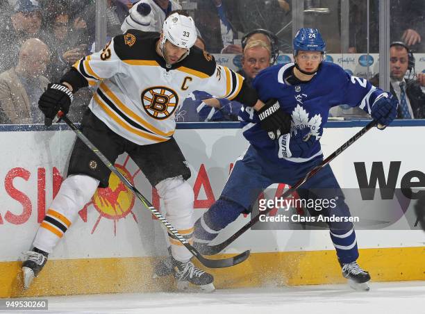 Zdeno Chara of the Boston Bruins battles against Kasperi Kapanen of the Toronto Maple Leafs in Game Four of the Eastern Conference First Round in the...