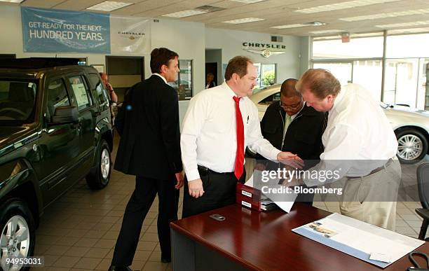 Mike Rafferty, sales manager, second left, Charles Martin, customer retention manager, center, and Jon Maston, sales consultant at the Lochmoor...