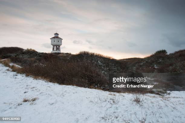water tower on snow-covered dunes in winter, langeoog, east frisia, lower saxony, germany - langeoog fotografías e imágenes de stock