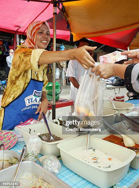 Normah Ahmad sells food for the breaking of fast at a market near Kota Bharu in Kelantan, Malaysia, on Wednesday, Sept. 9, 2009. Growing Islamic...