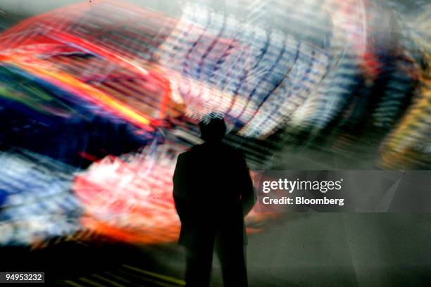 Slow shutter speed blurs a giant video screen during a presentation by Jack Tretton, president and chief executive officer of Sony Computer...
