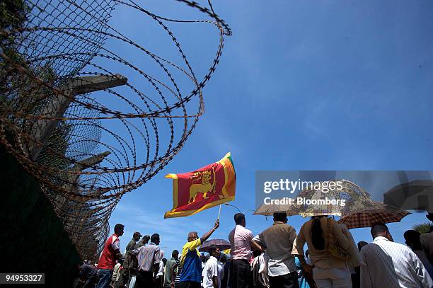 Man waves the Sri Lankan national flag at the National Victory Parade in Colombo, Sri Lanka, on Wednesday, June 3, 2009. Sri Lankan President Mahinda...