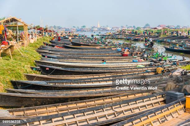 many wooden boats lined up at dock in the harbor, nampan, inle lake, shan state, myanmar - intha fisherman stock pictures, royalty-free photos & images