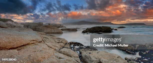 rocky beach at twilight, noordhoek, hout bay, south africa - noordhoek stock-fotos und bilder