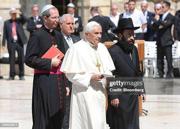 Pope Benedict XVI, front left, walks with the Western Wall's chief Rabbi, front right, as they approach the wall in the old city of Jerusalem, on...