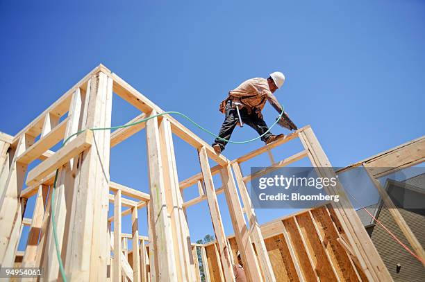 Nicolas Ramos frames the second floor of a home under construction in Alpharetta, Georgia, U.S., on Friday, March 20, 2009. The deepening economic...