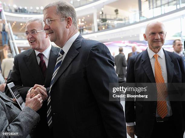 Martin Winterkorn, chief executive officer of Volkswagen AG, left, Wendelin Wiedeking, chief executive officer of Porsche SE, center, and Ferdinand...