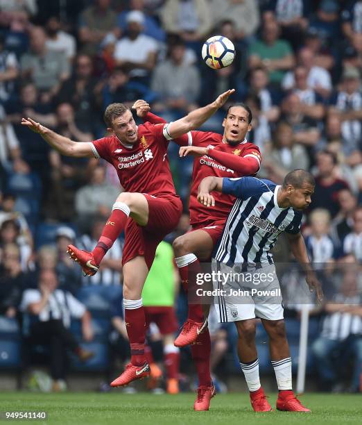 Jordan Henderson and Virgil van Dijk of Liverpool with Salomon Rondon of West Bromwich during the Premier League match between West Bromwich Albion...