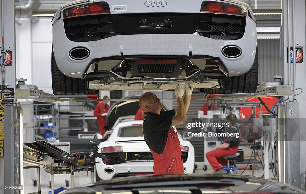An Audi AG employee performs a final check on an Audi R8 aut