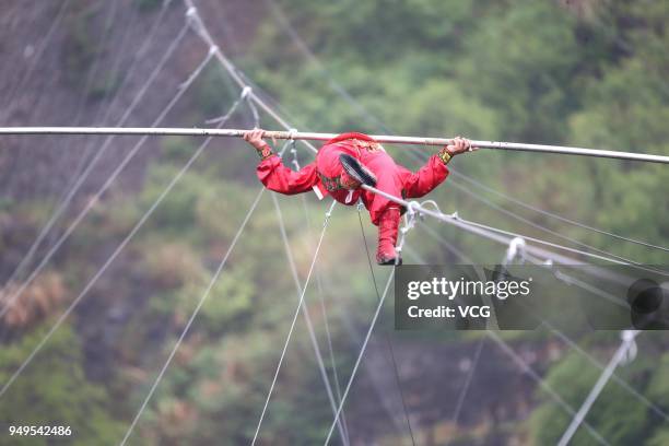 Chinese stuntman Saimaiti Aishan, seventh generation of the Dawazi, walks on the tightrope above a mining pit at Huangshi National Mine Park on April...