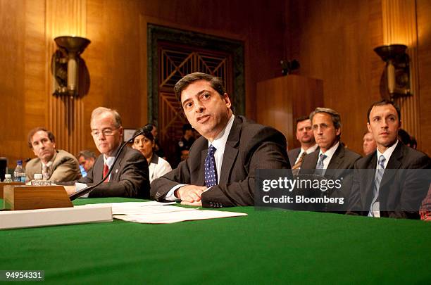 Robert Khuzami, director of enforcement of the U.S. Securities and Exchange Commission, center, speaks during a hearing of the Senate Banking...