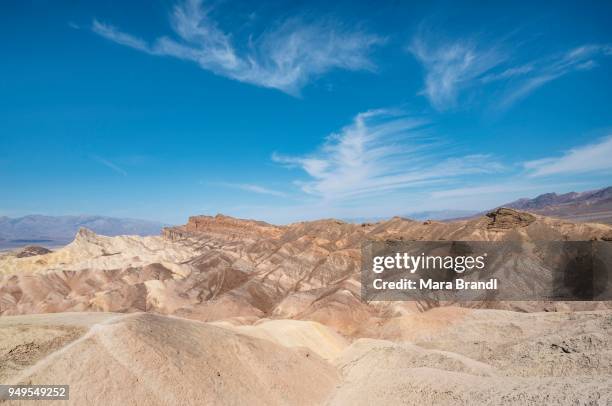 badlands, rock formations at zabriskie point, behind panamint range, death valley national park, california, usa - panamint range stock pictures, royalty-free photos & images