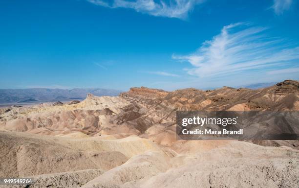 badlands, rock formations at zabriskie point, behind panamint range, death valley national park, california, usa - panamint range stock pictures, royalty-free photos & images