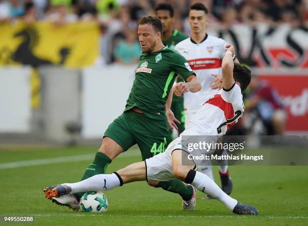 Philipp Bargfrede of Bremen is challenged by Mario Gomez of Stuttgart during the Bundesliga match between VfB Stuttgart and SV Werder Bremen at...