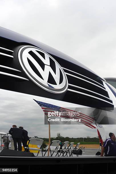 The American flag is reflected in the bumper of a new Volkswagen Jetta at a Volkswagen AG plant under construction, during an event in Chattanooga,...