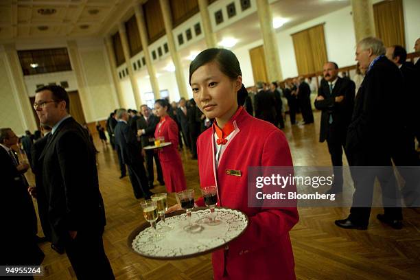 Waitress serves drinks during a dinner at the 2009 Institute of International Finance Spring Membership Meeting in Beijing, China, on Thursday, June...