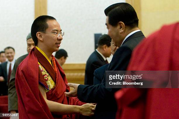 Gyaincain Norbu, the Beijing chosen Panchen Lama, left, greets Jia Qinglin, member of China's Polituro Standing Committee, after the opening of a...