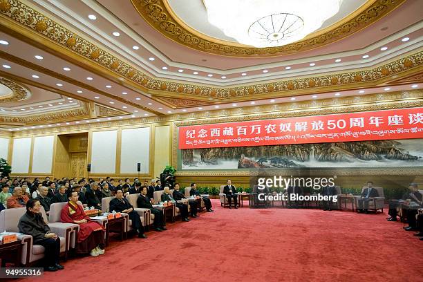Gyaincain Norbu, the Beijing chosen Panchen Lama, seated, second from left, attends the opening of a symposium in Beijing, China, on Friday, March...