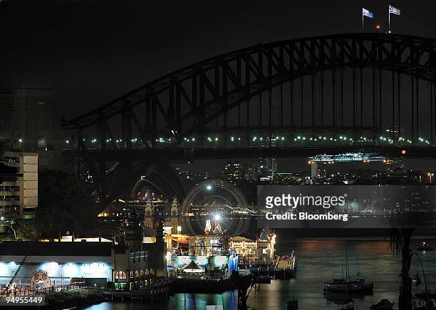 The Sydney Harbour Bridge, the Sydney Opera House and the city of Sydney are seen during Earth Hour in Sydney, Australia, on Saturday, March 28,...