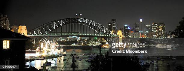 The Sydney Harbour Bridge, the Sydney Opera House and the city of Sydney are seen prior to Earth Hour in Sydney, Australia, on Saturday, March 28,...