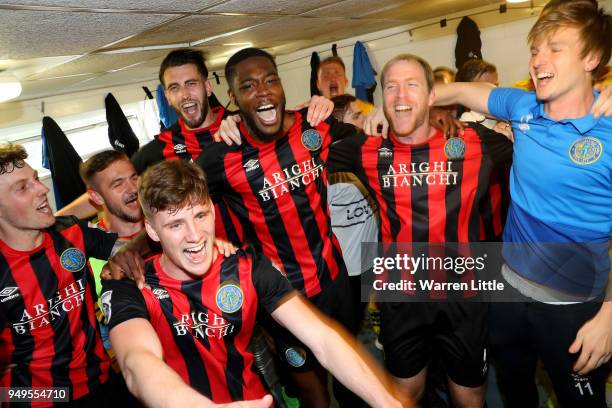 Macclesfield Town players celebrate in the changing room after gaining promotion during the Vanarama National League match between Eastleigh and...