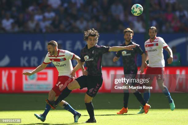 Aaron Hunt of Hamburg fights for the ball with Caglar Soeyuencue of Freiburg during the Bundesliga match between Hamburger SV and Sport-Club Freiburg...