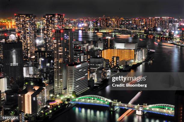 Buildings near Harumi pier are illuminated at night in Tokyo, Japan, on Sunday, Sept. 13, 2009. Commercial buildings stand at night in Tokyo, Japan,...