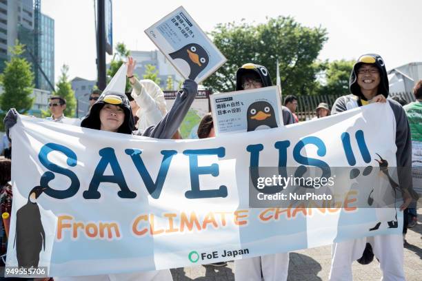 Activists hold placards during the Annual Earth Day in Shibuya district, Tokyo on 21 April 2018. Environmental activists commemorated Earth Day with...