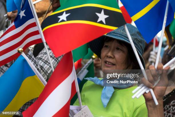 Activist shouts slogan holding flags during the Annual Earth Day in Shibuya district, Tokyo on 21 April 2018. Environmental activists commemorated...