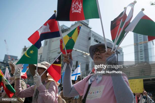 Activists hold flags during the Annual Earth Day in Shibuya district, Tokyo on 21 April 2018. Environmental activists commemorated Earth Day with a...