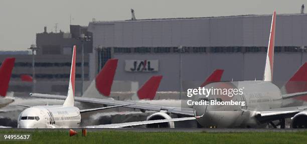 Japan Airlines Corp. Airplanes are parked at Haneda Airport in Tokyo, Japan, on Thursday, Sept.10, 2009. American Airlines, the world's...