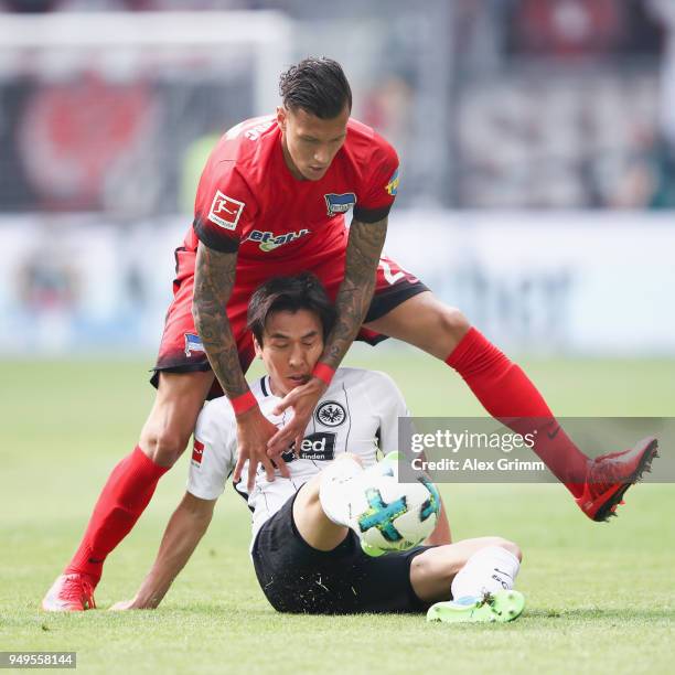 Makoto Hasebe of Frankfurt is challenged by Davie Selke of Berlin during the Bundesliga match between Eintracht Frankfurt and Hertha BSC at...
